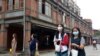 People wearing face masks to help curb the spread of the coronavirus walk on a street in Taipei, Taiwan, Oct. 19, 2020. (AP)