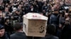 FILE - A White House summit this week is focusing on the international fight against terrorism. Here, pallbearers carry the coffin of terrorist victim Bernard Verlhac, a Charlie Hebdo cartoonist, in Montreuil, near Paris, Jan. 15, 2015. 