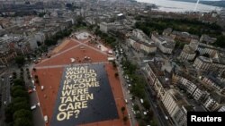 FILE - An 8,000-square-meter poster is pictured on the Plainpalais square in Geneva, Switzerland May 14, 2016. Swiss citizens will vote on the proposal for an "Unconditional Basic Income," June 5, 2016.