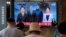 A TV shows a file image of North Korean leader Kim Jong Un, third from left, and South Korean President Moon Jae-in, second from left, during a news program at the Seoul Railway Station in Seoul, South Korea, July 27, 2021.