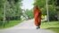 Buddhist monk Sutham Nateetong walks along the road outside Arcola, IN. June 8, 2019.