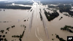 FILE - In this Aug. 29, 2017 file photo, Interstate 69 is covered by floodwaters from Harvey, in Humble, Texas. Just two weeks ago, President Donald Trump rolled back an order by his predecessor that would have made it easier for storm-ravaged communities