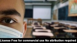 Boy with mask in a classroom