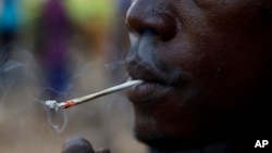 A young man smokes Kush at a hideout in Freetown, Sierra Leone, Monday, April 29, 2024. (AP Photo/ Misper Apawu)