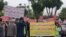 Dozens of Iranian education activists stage a protest outside the government's planning and budget office in Tehran, May 10, 2018. The protesters held signs calling for teachers to be paid at least more than Iran’s minimum wage (yellow sign, right) and for education to remain free for all Iranians (white sign, left). (Activist photo sent to VOA Persian) 