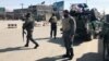 Policemen keep watch near the side of an attack in Kabul, Afghanistan, March 7, 2019.