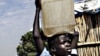 A Sudanese boy carries water home for his family.