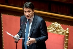 FILE - Italian premier Giuseppe Conte informs the Senate on coronavirus situation, in Rome, March 26, 2020.