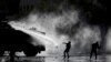 Police spray demonstrators with a water cannon during an anti-government protest in Santiago, Chile, Nov. 5, 2019.