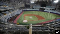 A worker wearing protective gears disinfects as a precaution against the new coronavirus at Gocheok Sky Dome in Seoul, South Korea, March 17, 2020. 