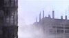In this image from an amateur video and released by the Syrian Media Council, smoke rises following purported shelling in Homs, Syria, April 10, 2012.
