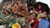 n this June 13, 2012 file photo, Rohingya Muslims who fled Burma to Bangladesh to escape religious violence, sit in a boat after being intercepted crossing the Naf River by Bangladeshi border authorities in Taknaf, Bangladesh.