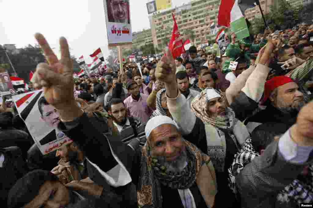 Supporters of Egyptian President Mohamed Mursi and members of the Muslim Brotherhood chant pro-Mursi slogans during a rally in Rabaa El Adaweya Mosque square in Cairo December 14, 2012.