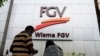 A couple talks outside FGV Holdings Berhad, one of Malaysia's largest palm oil companies, in Kuala Lumpur, Thursday, Oct. 1, 2020. Malaysian palm oil producer FGV Holdings Berhad vowed Thursday to “clear its name” after the U.S. banned imports of…