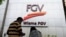 A couple talks outside FGV Holdings Berhad, one of Malaysia's largest palm oil companies, in Kuala Lumpur, Thursday, Oct. 1, 2020. Malaysian palm oil producer FGV Holdings Berhad vowed Thursday to “clear its name” after the U.S. banned imports of…