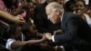 Vice President Joe Biden greets Lawrence Smith, 8, and Madison King, 9, both of Van Buren Township, Michigan, during a campaign stop at Renaissance High School in Detroit, Michigan, August 22, 2012.