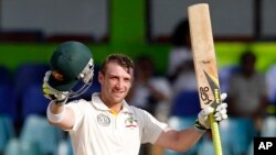 FILE - Australia's batsman Phillip Hughes celebrates after scoring a century.