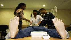 'Wonder' students Bongiwe Tyhala (left), Pumza Ghu (middle) and Gerald Maarman, practice medical procedures on a dummy at Stellenbosch University's Tygerberg faculty of medicine