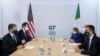 US Secretary of State Antony Blinken, left, sits opposite Italian Foreign Minister Luigi Di Maio, during a meeting on the first day of the G7 foreign ministers' summit, in Liverpool, England, Dec. 11, 2021. 