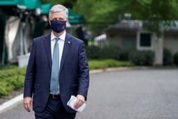 FILE - White House National Security Adviser Robert O'Brien walks after being interviewed at the White House in Washington, May 24, 2020.