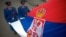 FILE - Serbian soldiers hold their country's flag in Belgrade. 