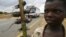 A boy displays boiled rats for sale on the main highway in Malawi's capital Lilongwe June 20, 2009.