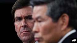 Defense Secretary Mark Esper, left, listens as South Korean National Defense Minister Jeong Kyeong-doo, right, speaks during a news conference at Pentagon in Washington, Monday, Feb. 24, 2020. (AP Photo/Susan Walsh)