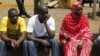 Relatives wait for the bodies of slain police officers to arrive at Wilson Airport Nairobi, Kenya, Tuesday, Nov. 13, 2012. Suspected cattle thieves hid on a high hill and ambushed and killed at least 34 police officers pursuing them over the weekend in no
