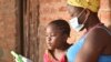 A student works with her mother on a lessons using a tablet provided by British charity Voluntary Services Overseas, in Malawi. (Photo courtesy of VSO/Craig Mawanga)