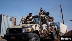 FILE - Army soldiers are seen at a checkpoint outside Amran city, the capital of Amran province, north of Sanaa, amid tension with militants of the Shi'ite Houthi group, Apr. 13, 2014. 