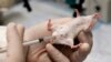 FILE - A laboratory mouse is seen receiving an injection.