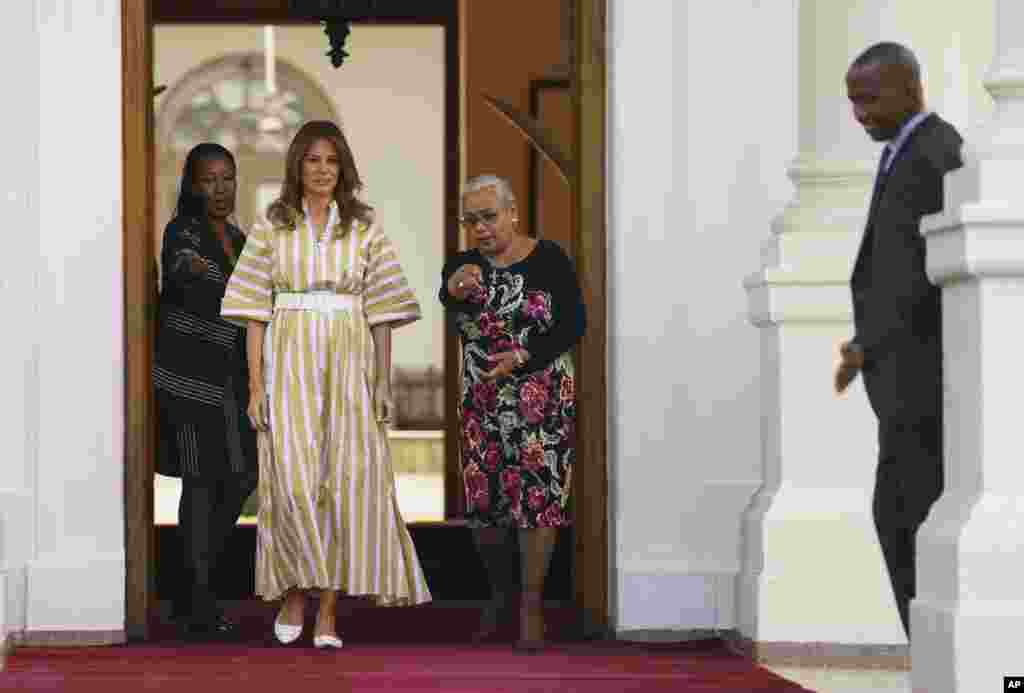 First lady Melania Trump is guided by Margaret Kenyatta, the wife of Kenyan President Uhuru Kenyatta, second from left, and others as first lady Melania Trump arrives at the State House in Nairobi, Kenya, Oct. 5, 2018.