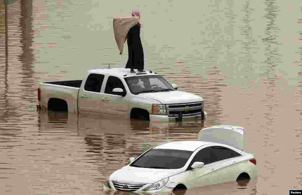 Cars are partially submerged in floodwater following heavy rains in Riyadh, Saudi Arabia.