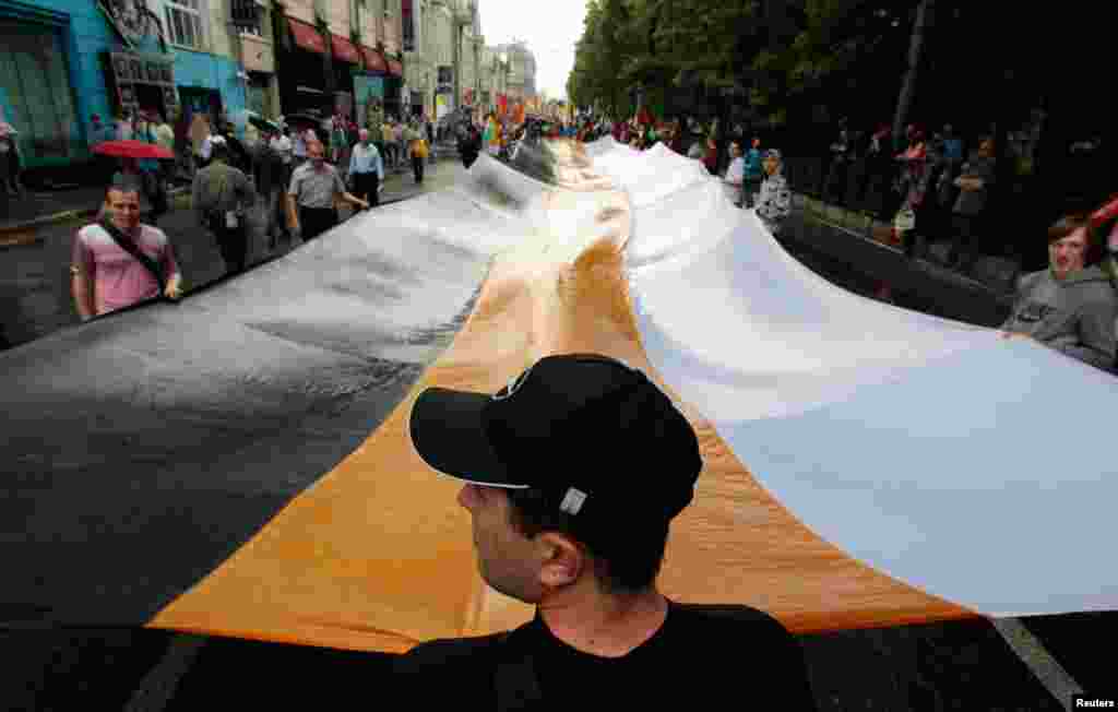 Activists hold a huge Russian Empire flag during protests in Moscow.