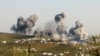 FILE - Smoke rises after what activists said was an airstrike on Atimah, Idlib province, March 8, 2015. 