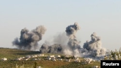 FILE - Smoke rises after what activists said was an airstrike in northern Syria March 8, 2015. 