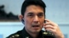 FILE - Winthai Suvaree, a spokesman for the Thai military government's NCPO, speaks on his mobile phone during an interview with Reuters at the Royal Army headquarters in Bangkok, Sept. 11, 2014.