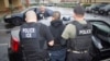 FILE - photo released by U.S. Immigration and Customs Enforcement shows foreign nationals being arrested this week during a targeted enforcement operation conducted by U.S. Immigration and Customs Enforcement (ICE).