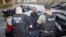 FILE - photo released by U.S. Immigration and Customs Enforcement shows foreign nationals being arrested this week during a targeted enforcement operation conducted by U.S. Immigration and Customs Enforcement (ICE).