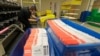 Vote-by-mail ballots are shown in sorting trays, Wednesday, Aug. 5, 2020, at the King County Elections headquarters in Renton, Wash., south of Seattle.