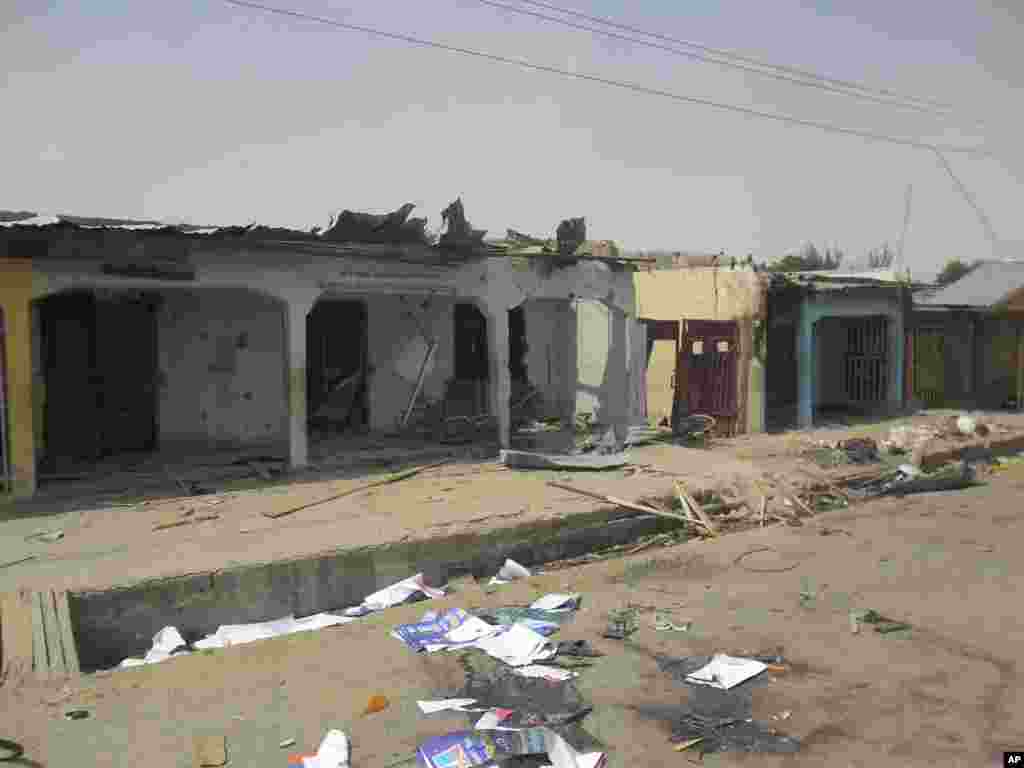 Damaged buildings and bloodstains on the street can be seen following a suicide bomb explosion at a World Cup viewing center, Damaturu, Nigeria, June 18, 2014.