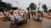 FILE PHOTO - Cambodian workers transport their goods brought from Thailand at a Cambodia-Thai international border gate in Poipet, Cambodia, Wednesday, June 18, 2014, for their daily business near the border between Cambodia and Thailand. (AP Photo/Heng S