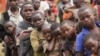 Refugee children, displaced by continued fighting in north Kivu province in the Democratic Republic of Congo (DRC), wait for food in the Nyakabande refugee transit camp in Kisoro town, 521 km (324 miles) southwest of Uganda's capital Kampala, July 13, 201