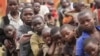 Refugee children, displaced by continued fighting in north Kivu province in the Democratic Republic of Congo (DRC), wait for food in the Nyakabande refugee transit camp in Kisoro town, 521 km (324 miles) southwest of Uganda's capital Kampala, July 13, 201