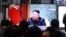 People watch a TV showing a file image of North Korean leader Kim Jong Un during a news program, March 25, 2021, at the Suseo Railway Station in Seoul, South Korea.