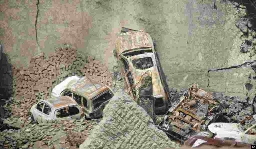 The collapsed upper car park of the Westgate Mall in Nairobi, Kenya. Working near bodies crushed by rubble in a bullet-scarred, scorched mall, FBI agents continued fingerprint, DNA and ballistic analysis to help determine the identities and nationalities of victims and al-Shabab gunmen who attacked the shopping center, killing more than 60 people.