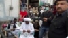 Mama Qadeer Baluch, wearing a white turban, chairman of the Voice for Baluch Missing Persons, waits to start a march with protesters in Rawalpindi, Pakistan, Feb. 27, 2014.