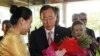 U.N. Secretary-General Ban Ki-moon, center left, and his wife Yoo Soon-taek, center right, receive flowers from a staff upon their arrival at a hotel Sunday, April 29, 2012 in Yangon, Burma.