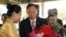 U.N. Secretary-General Ban Ki-moon, center left, and his wife Yoo Soon-taek, center right, receive flowers from a staff upon their arrival at a hotel Sunday, April 29, 2012 in Yangon, Burma.