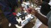 A vendor hawks second-hand mobile phones at the sprawling Kibera slum, one of the largest and poorest slums in Africa, near Kenya's capital Nairobi, August 26, 2011. 